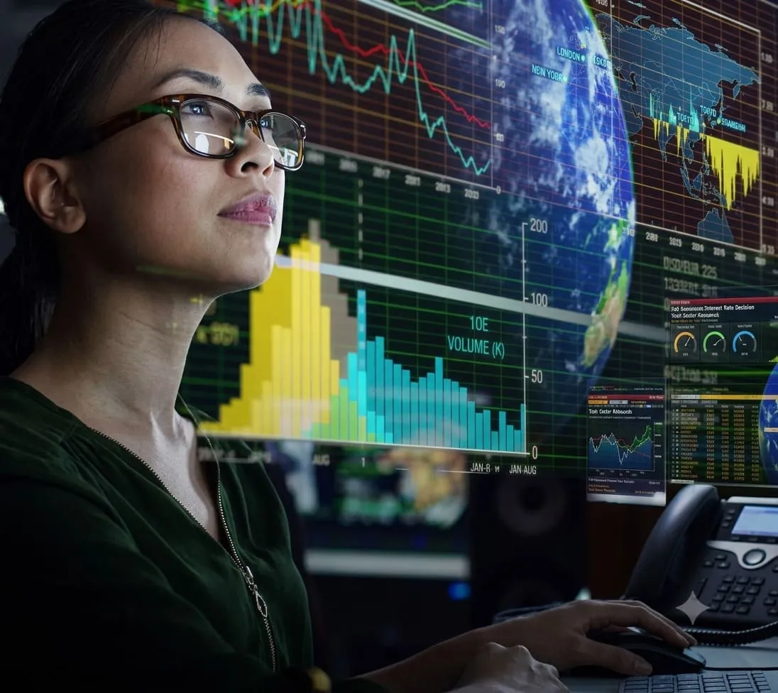 Analyst looking at data visualisations on large screens